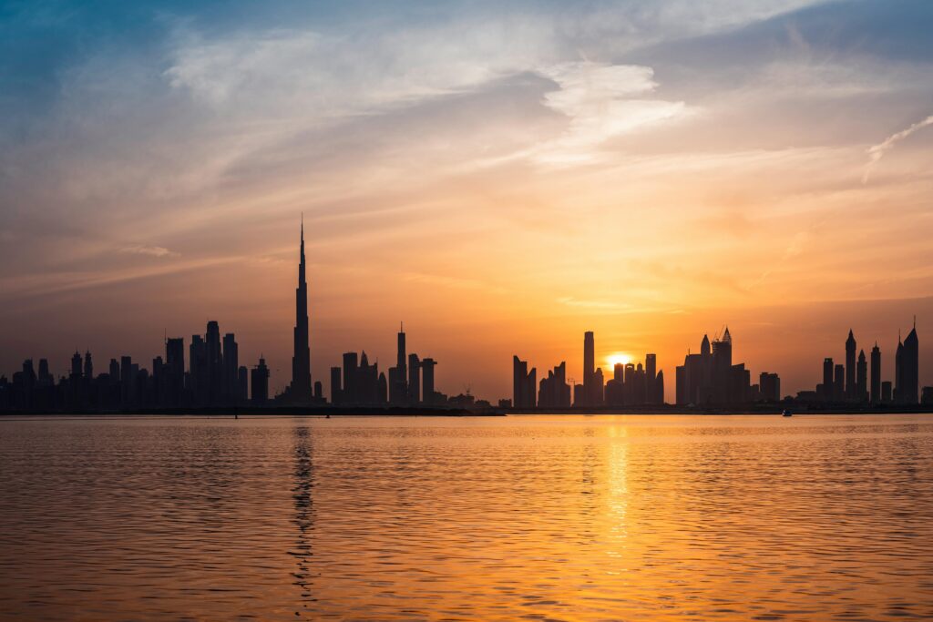 pexels-photo-2115367-2115367 Enchanting view of Dubai's skyscrapers at sunset with the iconic Burj Khalifa outlined against the vivid sky.